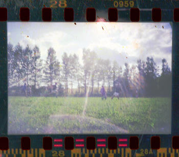 A game of football with intense lens flare from the sun